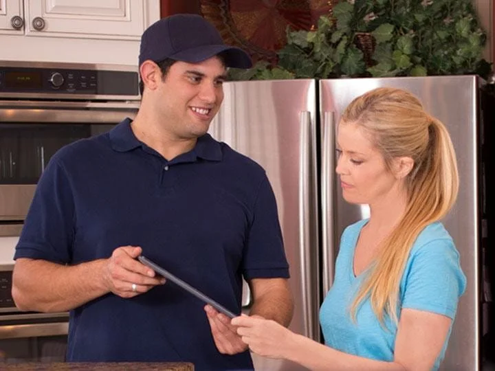 Beehive Plumbing plumber reviewing the work with customers